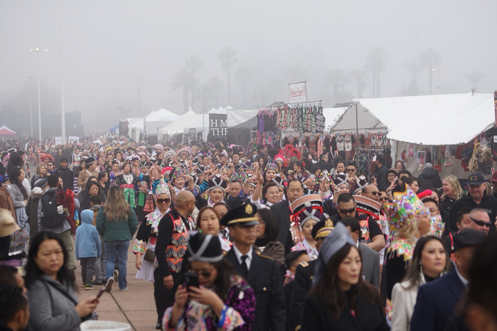 Crowds walking the fairgrounds between vendor tents.