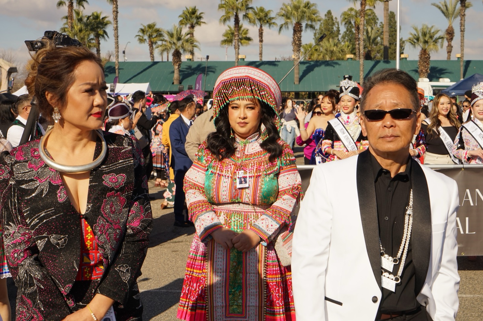 Two festival attendees in traditional dress on the fairgrounds.